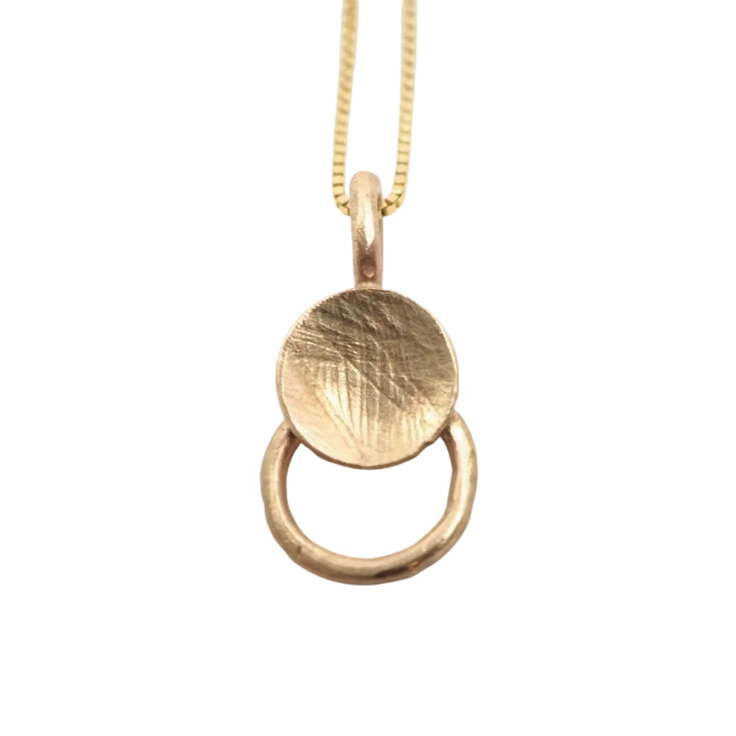 Gold necklace with a round pendant on a light gray background