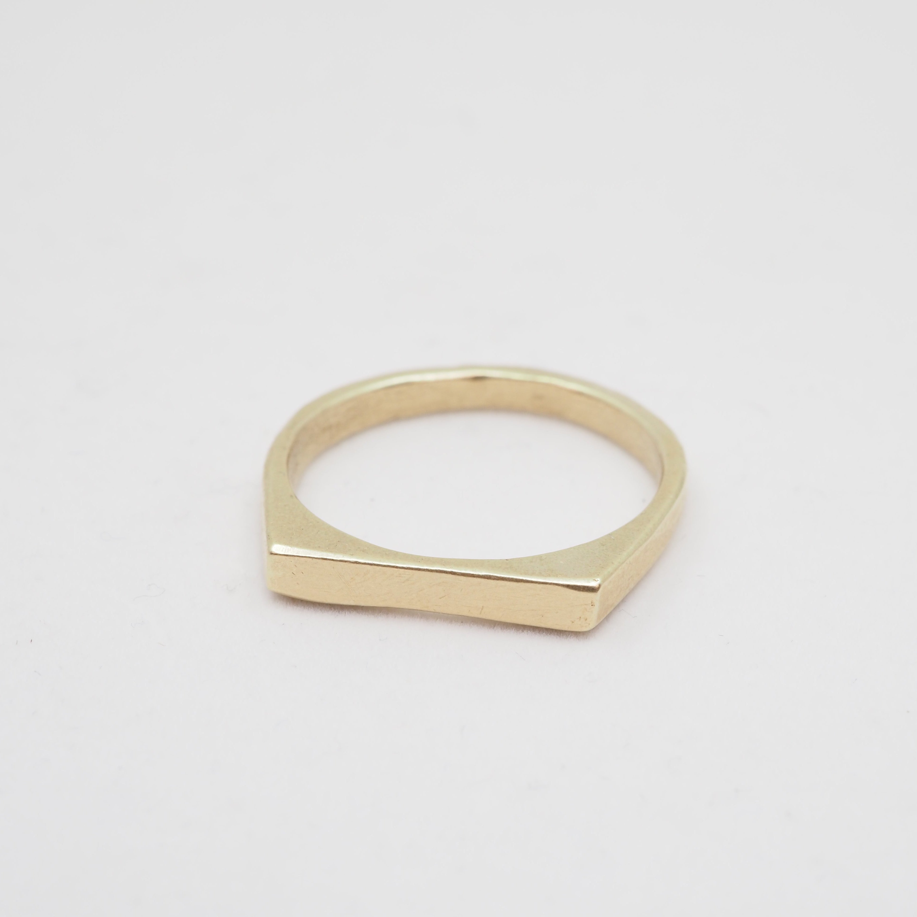 Gold ring on a light gray background