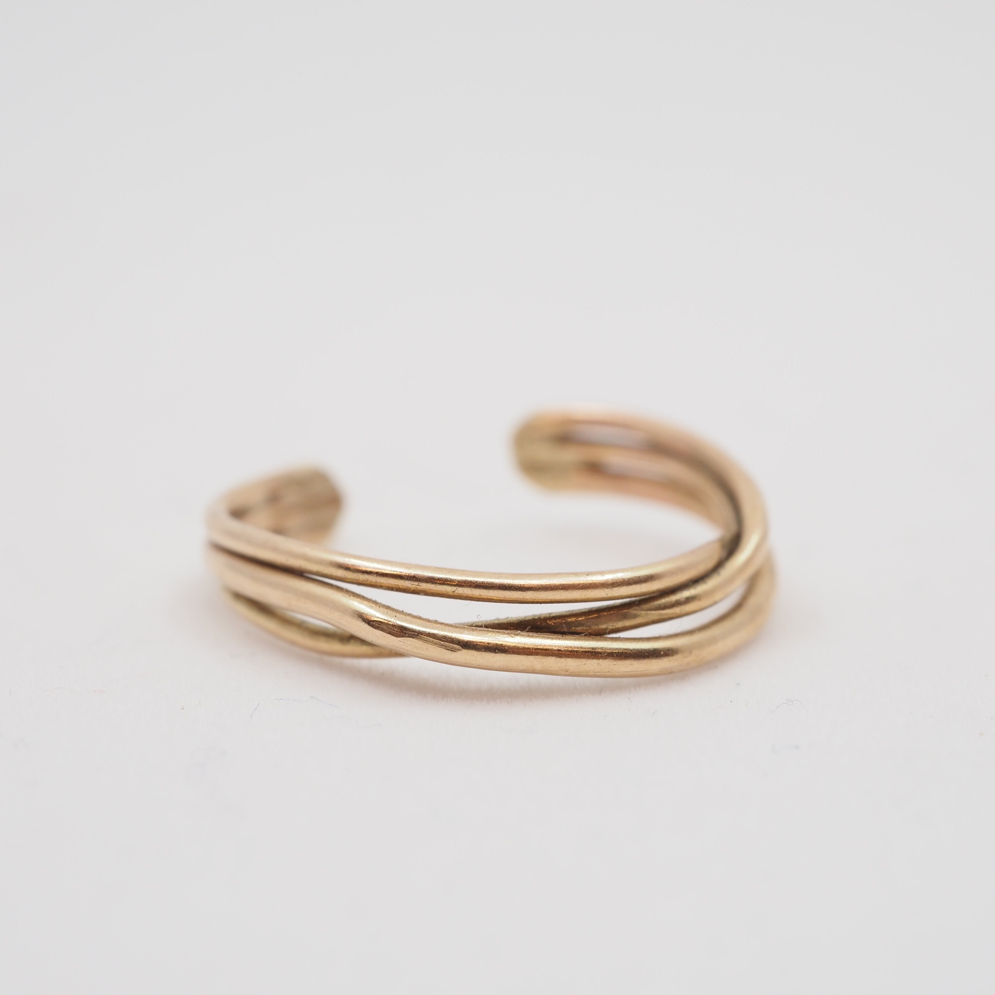 Gold ring on a light gray background