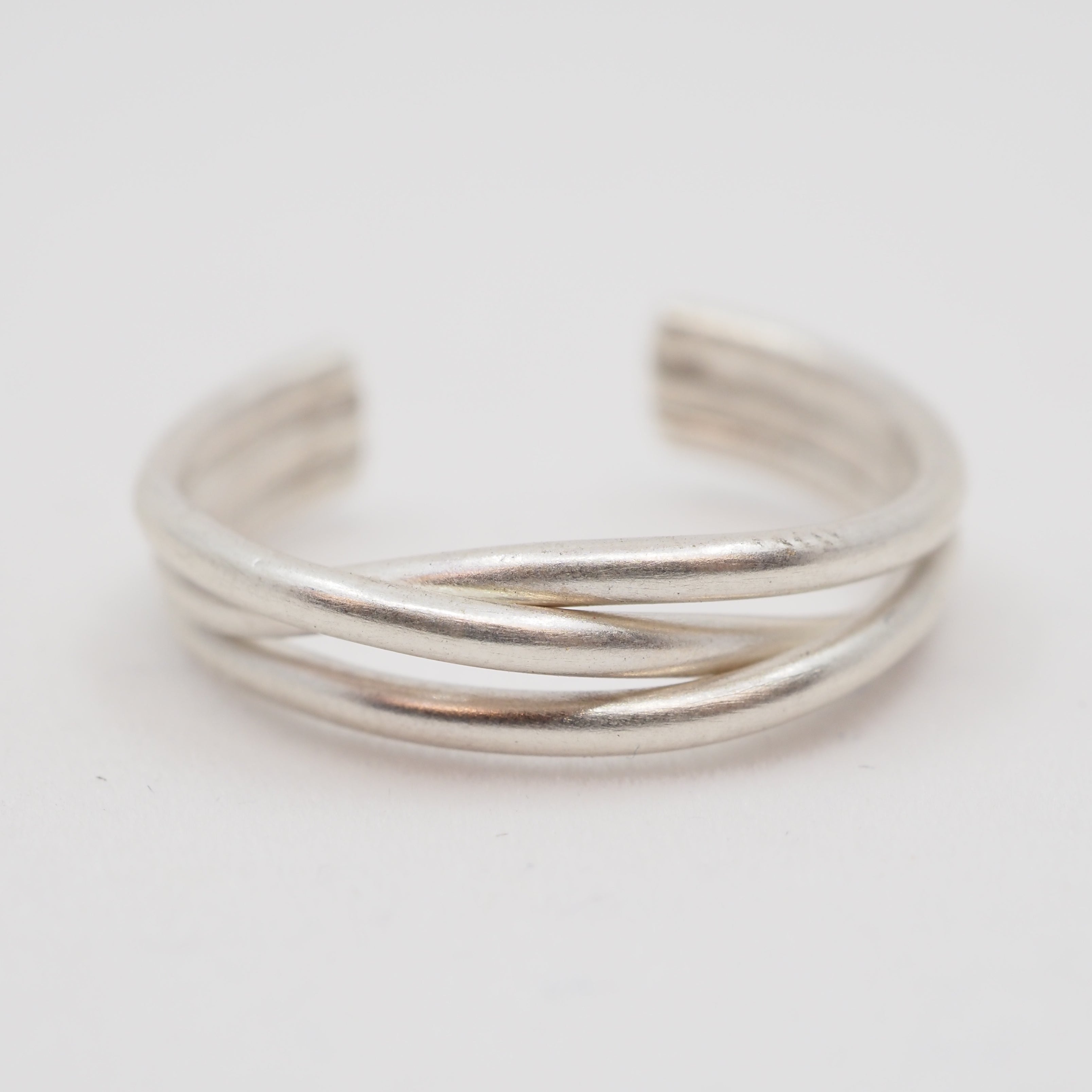 Silver ring on a light gray background