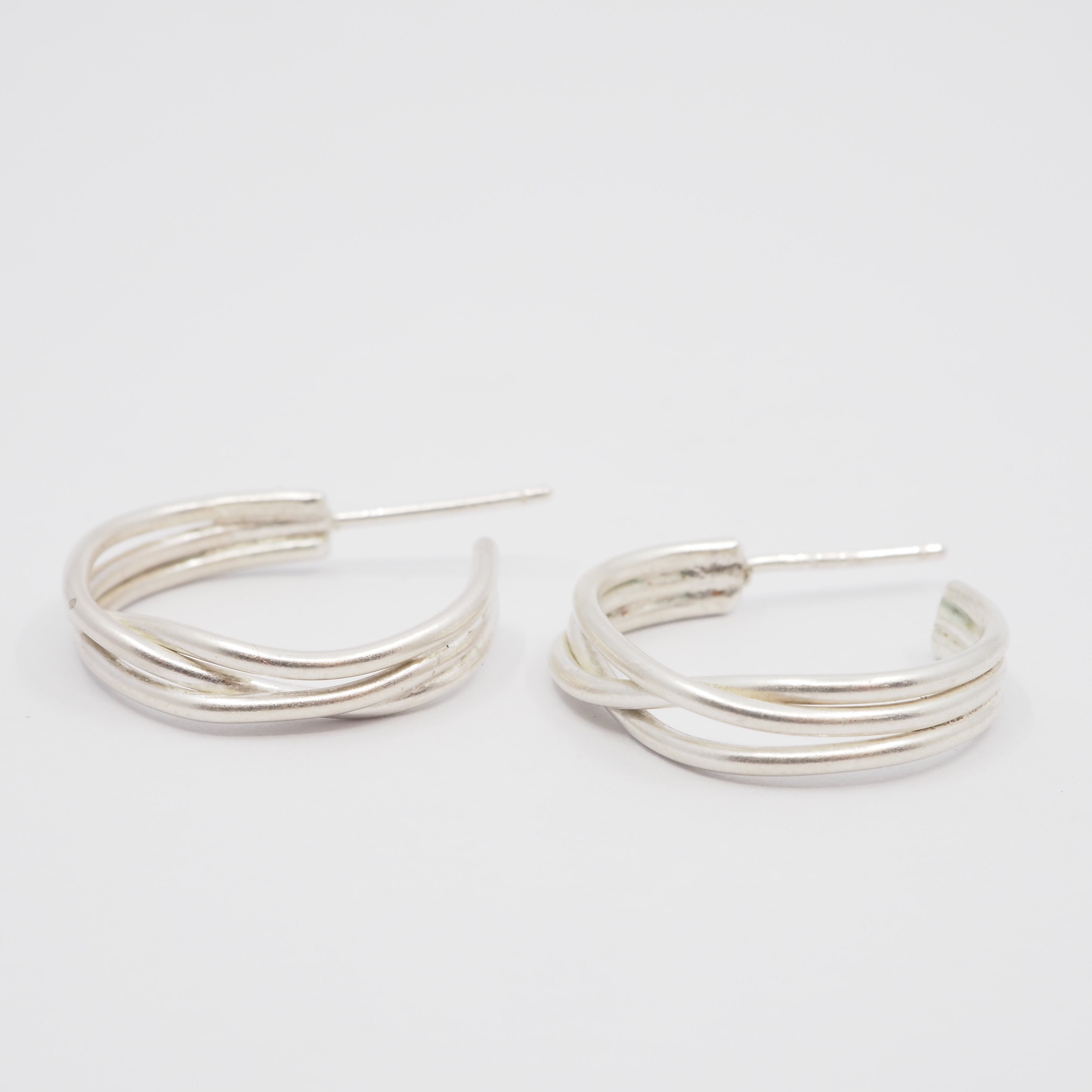 Silver hoop earrings on a white background