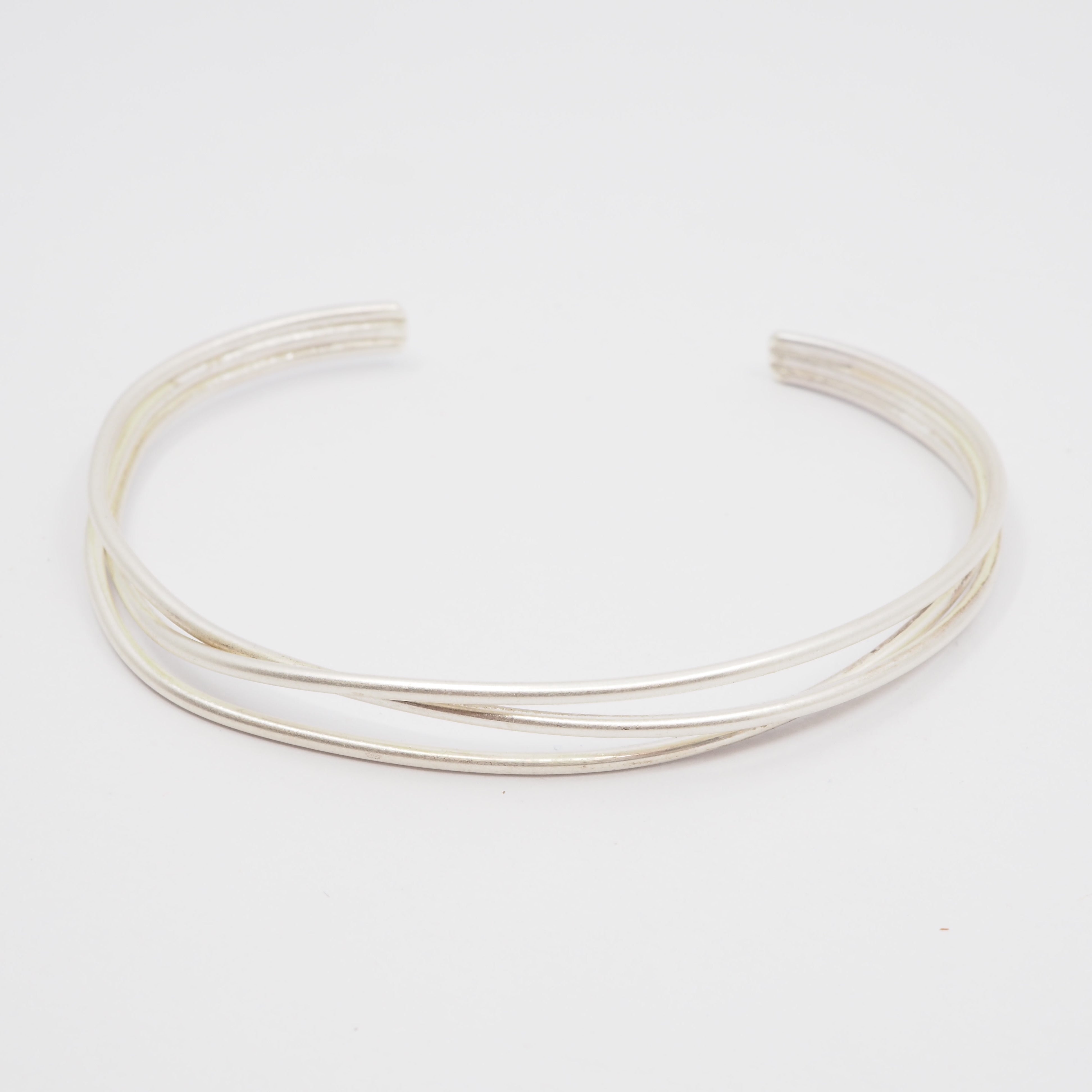 Silver bangle on a light gray background